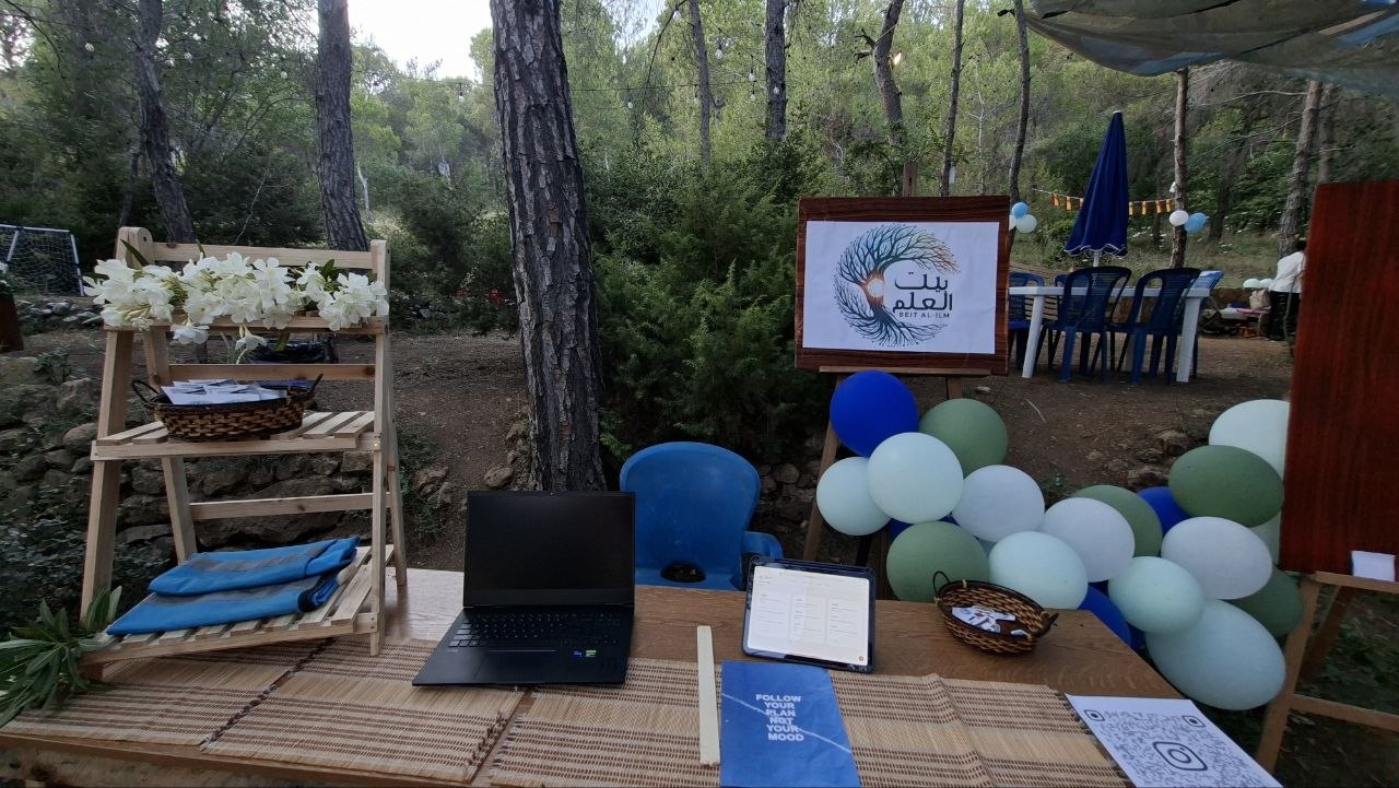 The team hosting a Beit Al-Ilm community event booth
