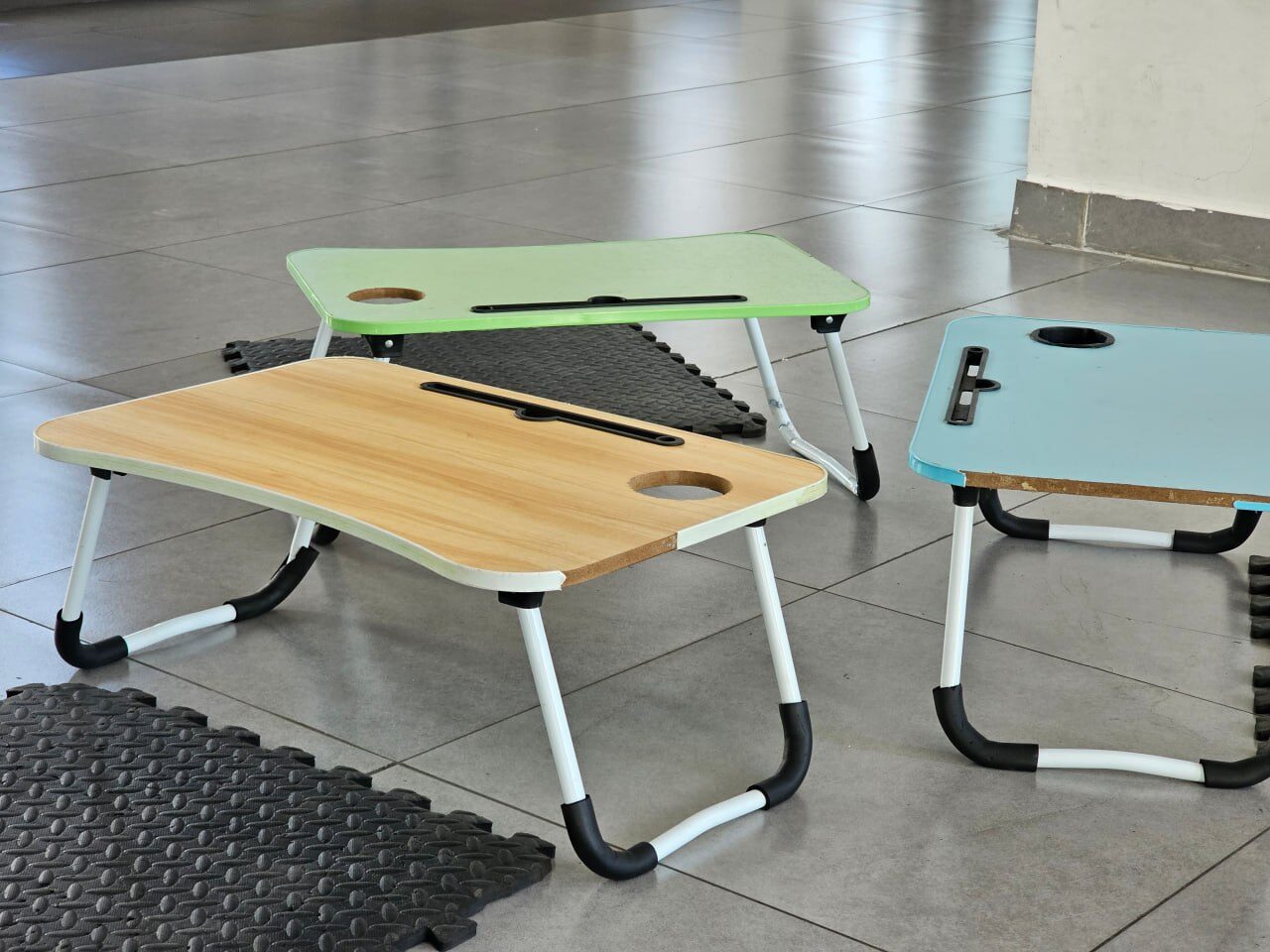 Colourful folding lap desks ready for a floor session