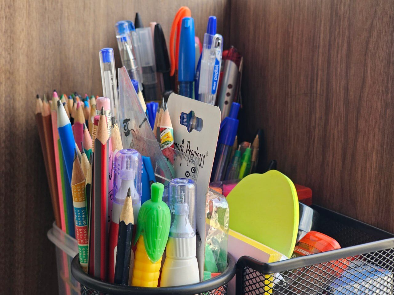 Pots of coloured pencils and pens